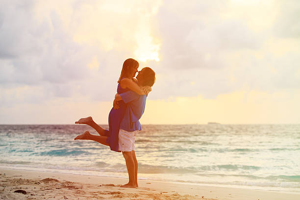 istock romantic couple on the beach at sunset 484639666