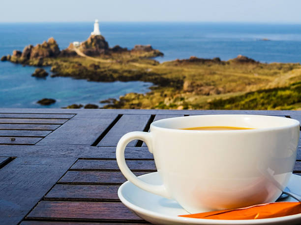 istock Big white cup on a table and seacoast as background 484639730