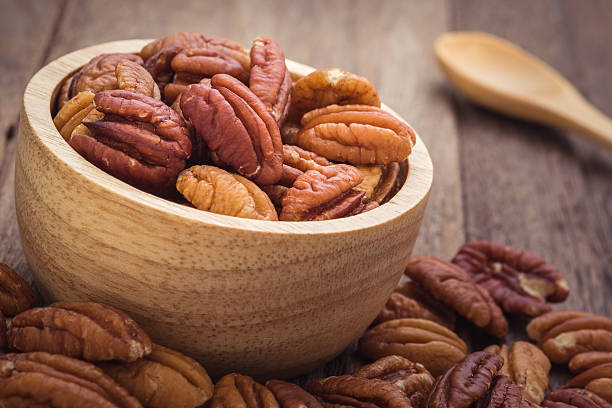 istock Pecan nuts in wooden bowl 484640328