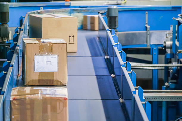 istock Parcels on conveyors with blurred industrial background 484643400