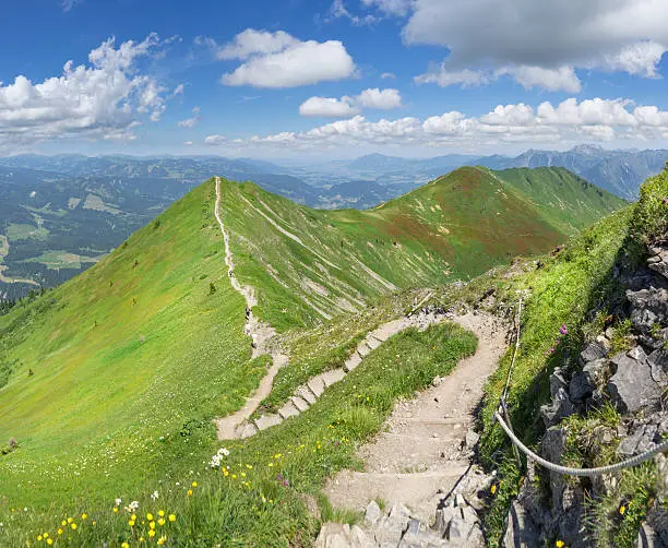 Ridge trail in the green summery Alps from Fellhorn to Soellereck in the Allgau Alps, above the Kleinwalsertal and Oberstdorf on the border between Austria and Germany. 