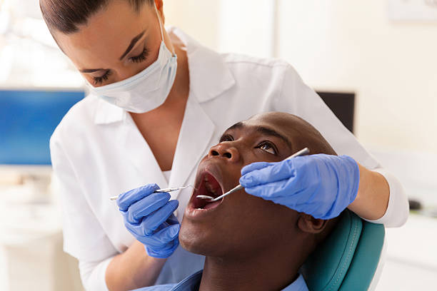 istock dentist examining male patient 484647860