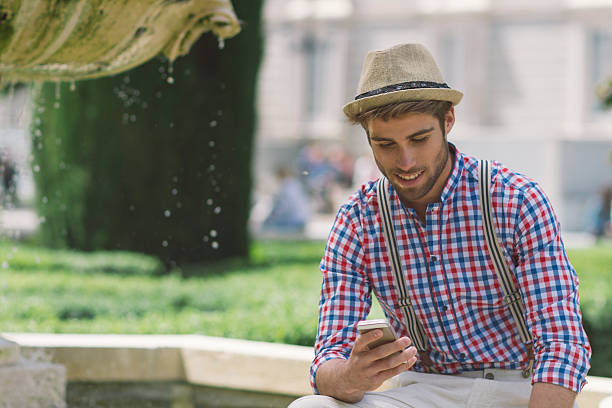 istock Man sitting looking at his mobile phone 484648436