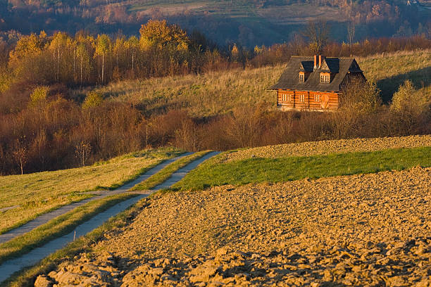 istock Cottage house in autumn fields 484648473