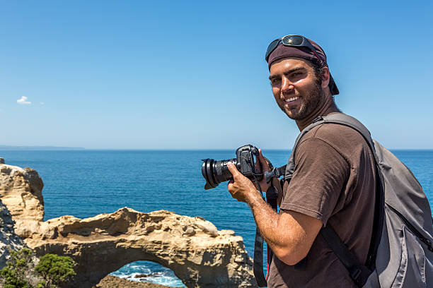 男性カメラマンの中に、デジタル一眼レフカメラで写真のビーチ - australia photographing camera beach ストックフォトと画像