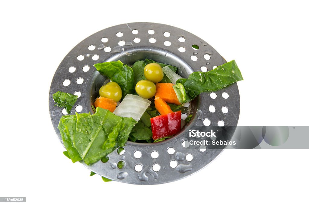 Dirty sink Drain sink full of old vegetables isolated over white background Commercial Kitchen Stock Photo