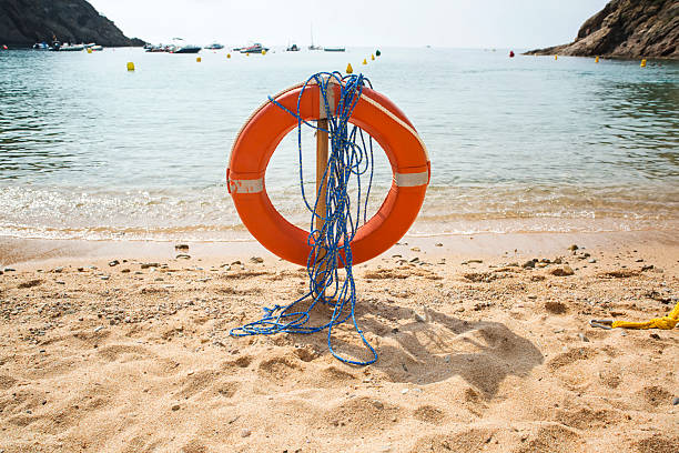 istock Red lifebuoy on a beach 484652884
