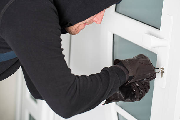 istock Burglar using special tools to break in  a house 484652993