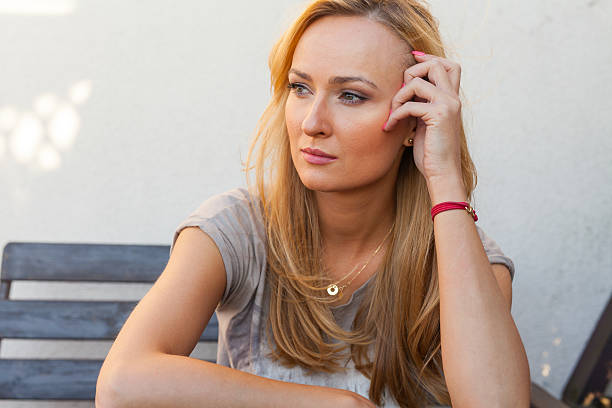 istock Sad girl sitting behind the table and supporting head-hand. 484657572