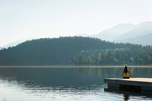 istock Easy Pose Tranquil Lakeside meditation at sunrise 484660550