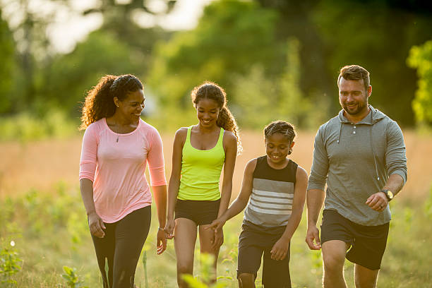 istock Family Walking Through a Field 484660804