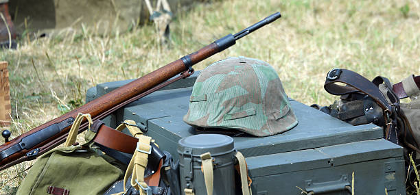 istock helmet of soldier uniform with a rifle 484664836