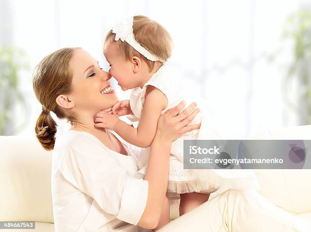 Happy Family Mother And Baby Daughter Plays Hugging Kissing Stock Photo - Download Image Now