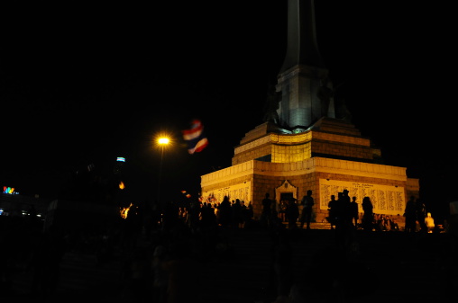 Bangkok, Thailand - December 22, 2013:Anti-government protesters wave Thai national flags at Victory Monument in central of Bangkok.