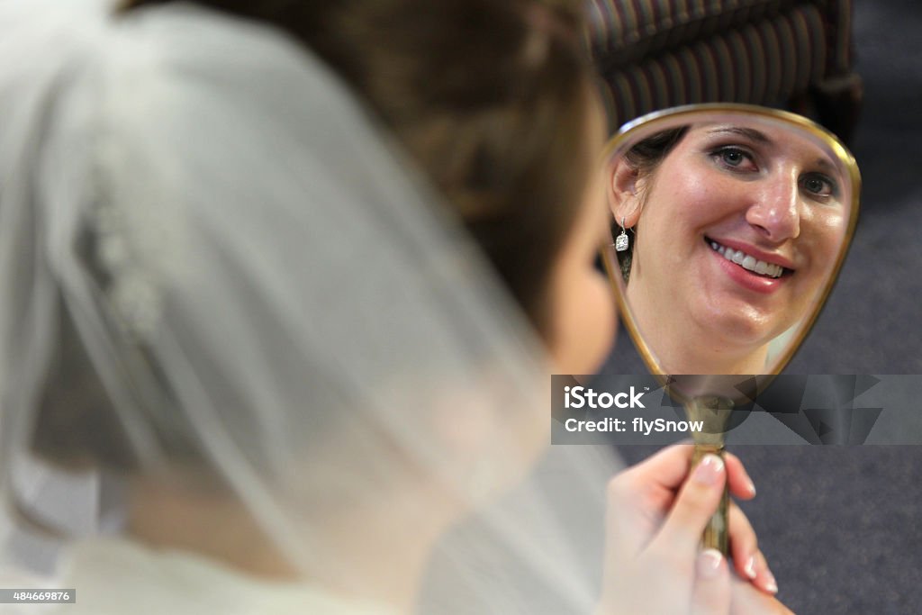 Bride A bride looking at a mirror. 2015 Stock Photo