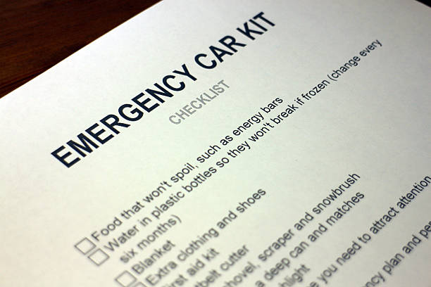 istock Someone filling out Emergency Car Kit Checklist 484670066