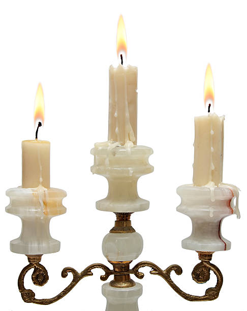 istock burning old candle vintage golden candlestick. onyx 484671499