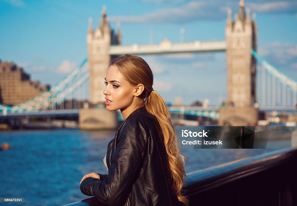 London sightseeing Side view of pensive young woman looking at Thames River with Tower Brigde in the background. 20-24 Years Stock Photo