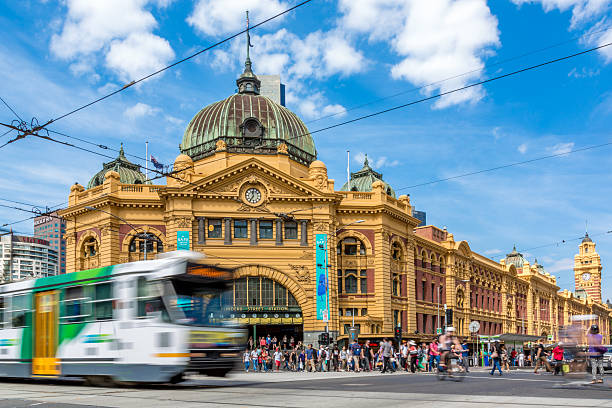 Flinders Street Station and Tram in Melbourne, Australia Melbourne, Australia- February 14, 2013: Pedestrians and cylers at the iconic Flinders Street Station in Melbourne, Australia victoria australia photos stock pictures, royalty-free photos & images