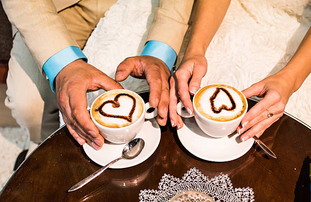 istock Hands of the groom and  bride with coffee cups 484673868