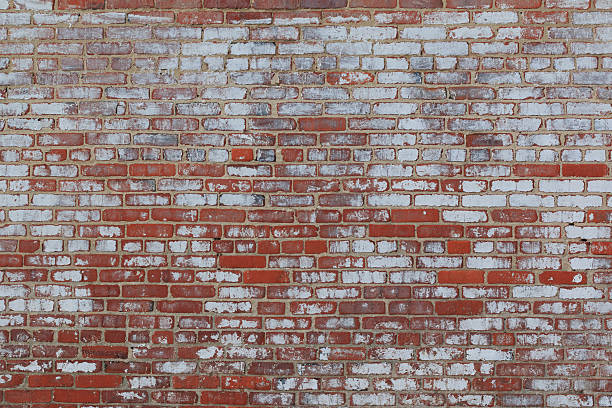 Rustic Red Brick Wall Background with Peeling White Paint stock photo