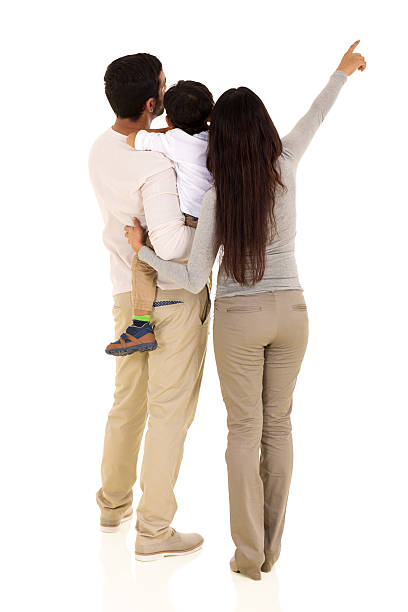 vista posteriore di famiglia indiana che indica - rear view family isolated child foto e immagini stock