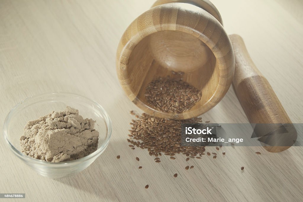 Flax seeds ground and a mortar Flax seeds ground and a mortar on the table 2015 Stock Photo