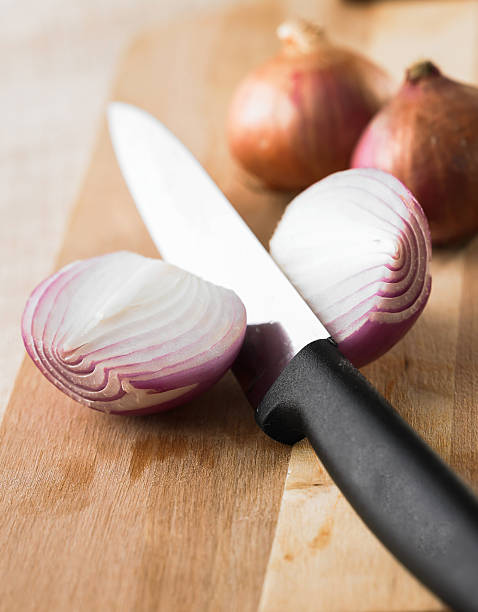 istock Sliced shallot onion on wood plate 484679982