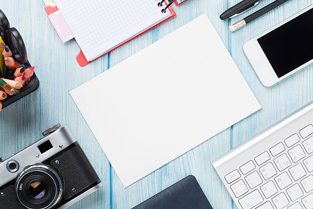 istock Office desk with supplies, camera and blank card 484683622