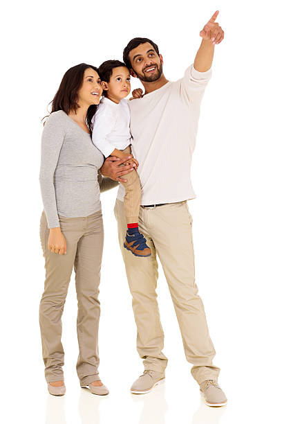 young indian family pointing cheerful young indian family pointing on white background happy indian young family couple stock pictures, royalty-free photos & images