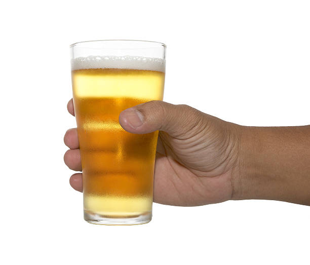 istock hands holding up a glass of beer 484684586
