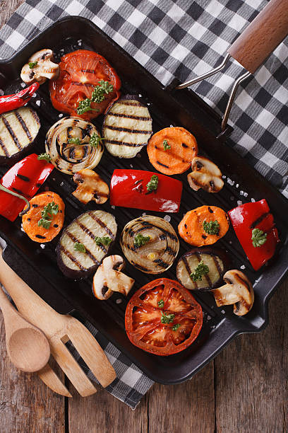 istock grilled peppers, tomatoes, onions, eggplant vertical top view 484684760