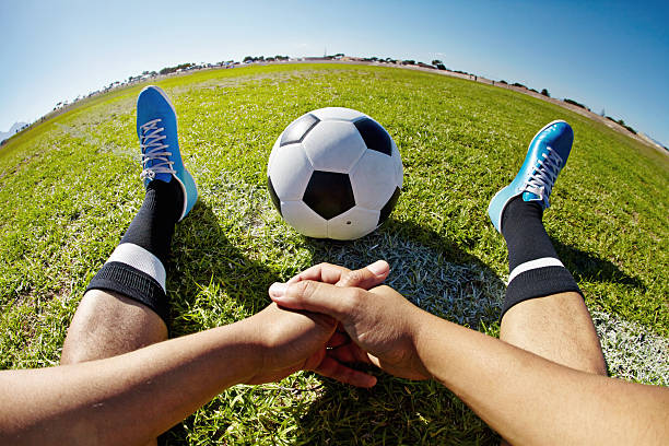 POV shot of a soccer player sitting with a soccer ball on a playing fieldhttp://195.154.178.81/DATA/i_collage/pi/shoots/805419.jpg
