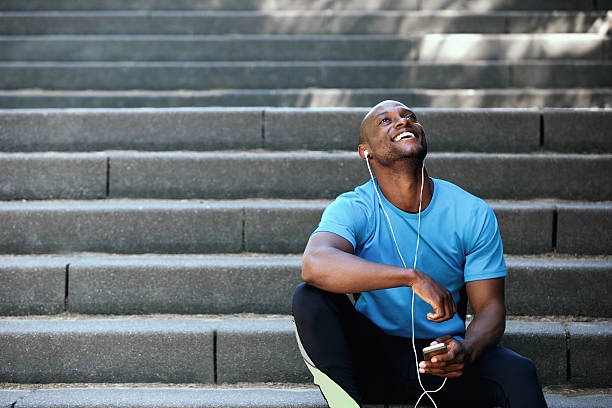 istock Happy man laughing with mobile phone and earphones 484687034