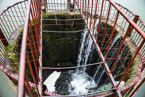 istock Water flowing into the round spillway on the dam 484687408