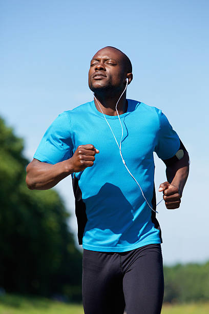 istock Fit young black man running outdoors 484692132