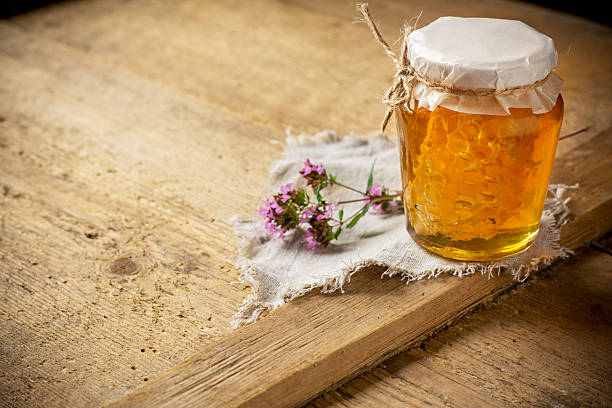 istock Jar of honey on wooden table 484693916