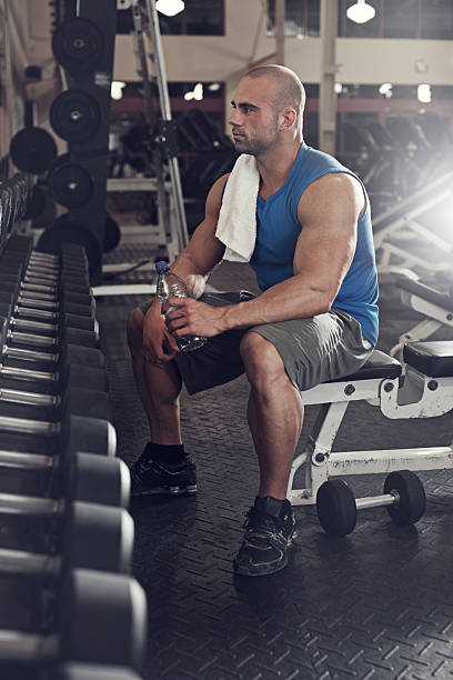 istock bodybuilder working out with bumbbells weights at the gym 484694090