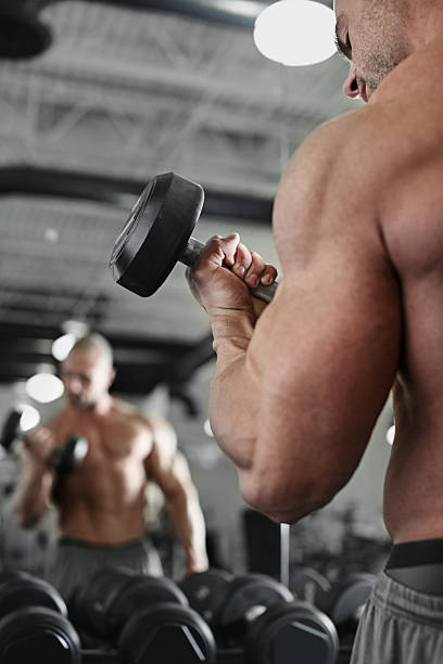 istock bodybuilder working out with bumbbells weights at the gym 484694112