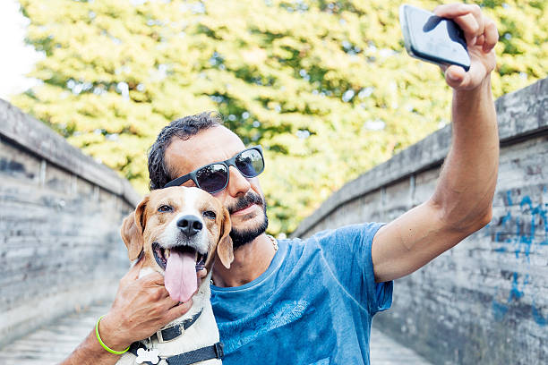 istock young man takes a selfie with his dog 484703348