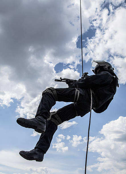 rappeling assault Special forces operator during assault rappeling with weapons gun laws stock pictures, royalty-free photos & images