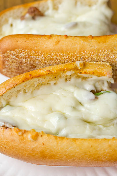 Philly Cheesesteak Philly Cheesesteak loaded with mozzarella cheese on submarine bun torpedo sandwich stock pictures, royalty-free photos & images