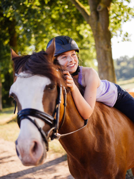 istock Girl leaning lovingly on her horse while riding in nature 484711808
