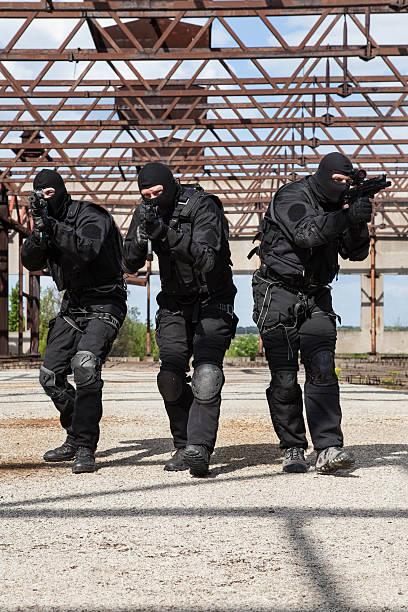 Special forces in action Special forces operators in black uniform in action spetsnaz stock pictures, royalty-free photos & images