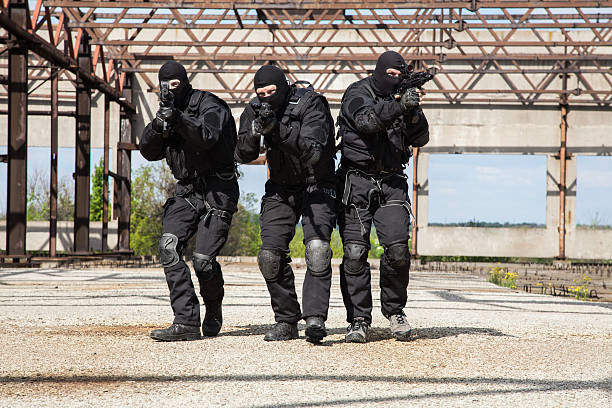 Special forces in action Special forces operators in black uniform in action spetsnaz stock pictures, royalty-free photos & images