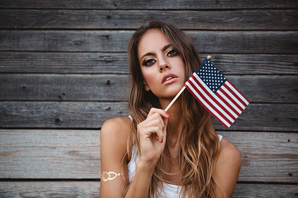 istock Young woman with American flag. 484712618