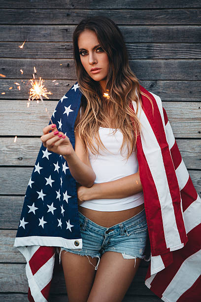 istock Young woman with American flag. 484712640