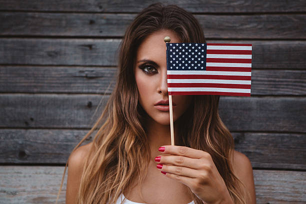 istock Young woman with American flag. 484712654