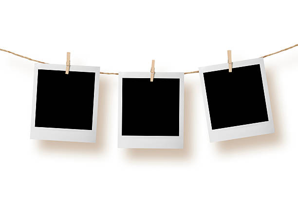 Blank instant photo Blank Photos on a Clothesline. string photos stock pictures, royalty-free photos & images