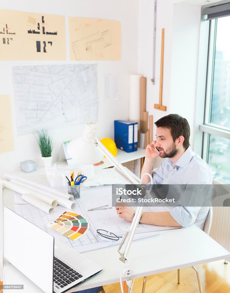 Young architect working Young female architect having a conversation on cellphone. 25-29 Years Stock Photo